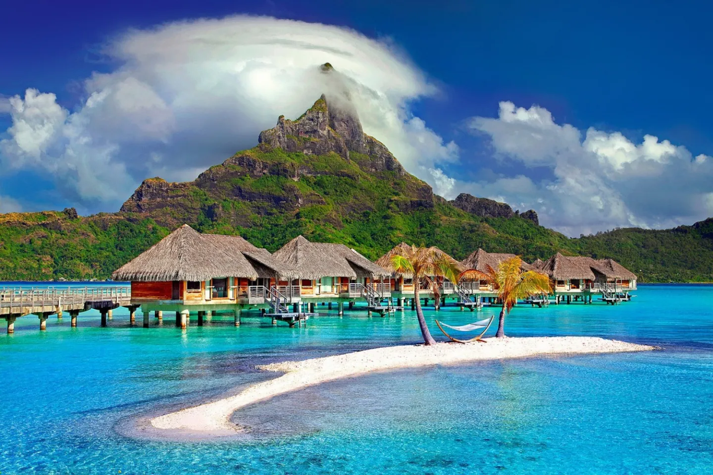 Tropical island resort with overwater villas and turquoise sea