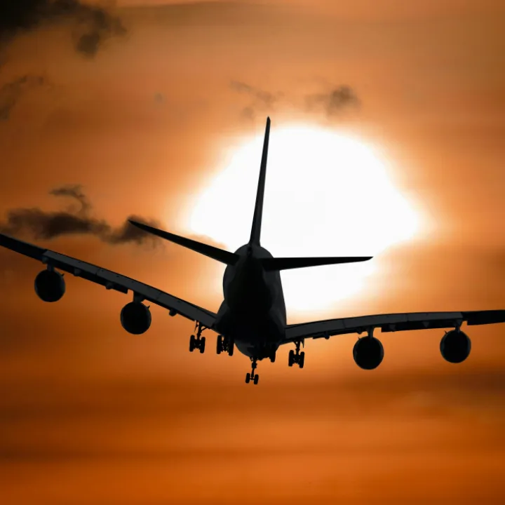 Plane flying during sunset